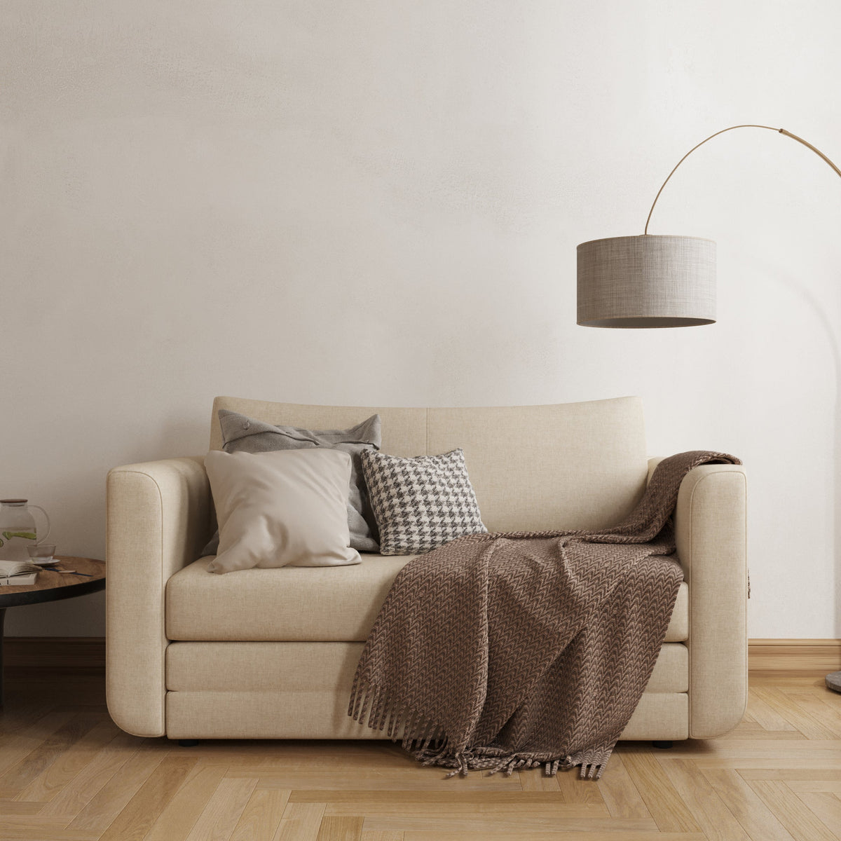 Cream convertible loveseat sofa bed styled in a minimalist small-space living room