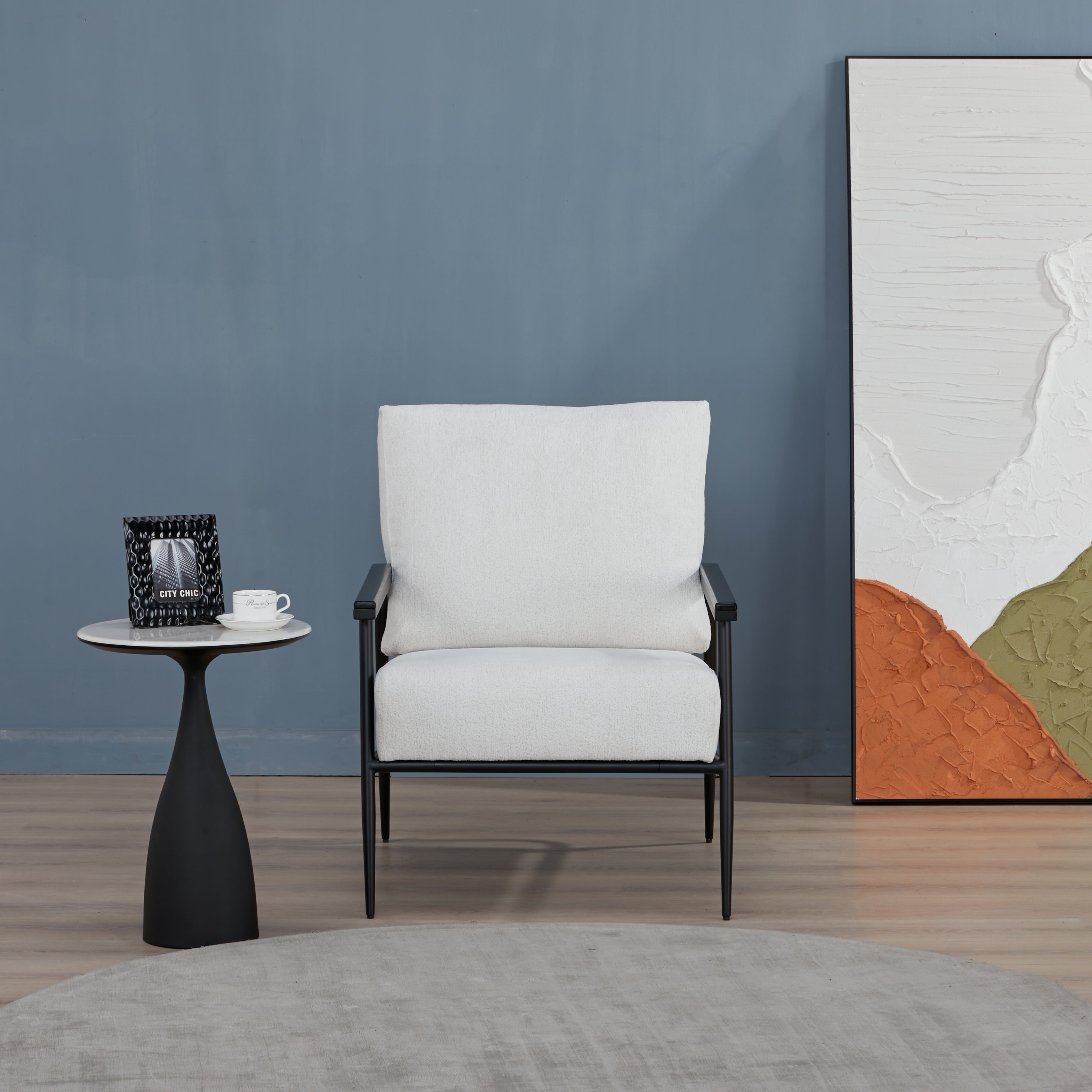 Parker Accent Chair in Sherpa Ivory displayed in a living room setting with a side table, floor lamp, blue wall, and ivory sherpa upholstery