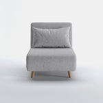 Tustin Convertible Chair in Moonlight shown from the front with a matching lumbar pillow, wide armless seat, upholstered backrest, and tapered natural wood legs.