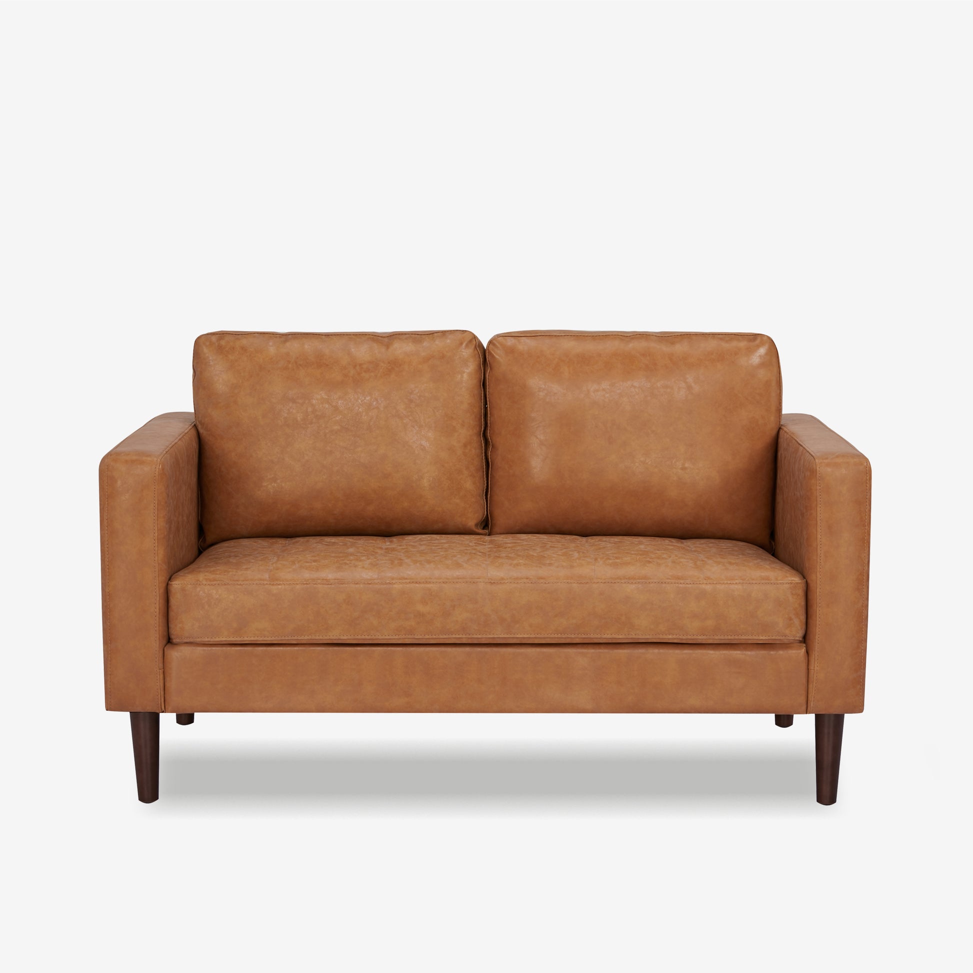 Orlando Loveseat in Faux Leather Camel shown from the front with two loose back cushions, a wide bench seat, track arms, and tapered dark brown legs.