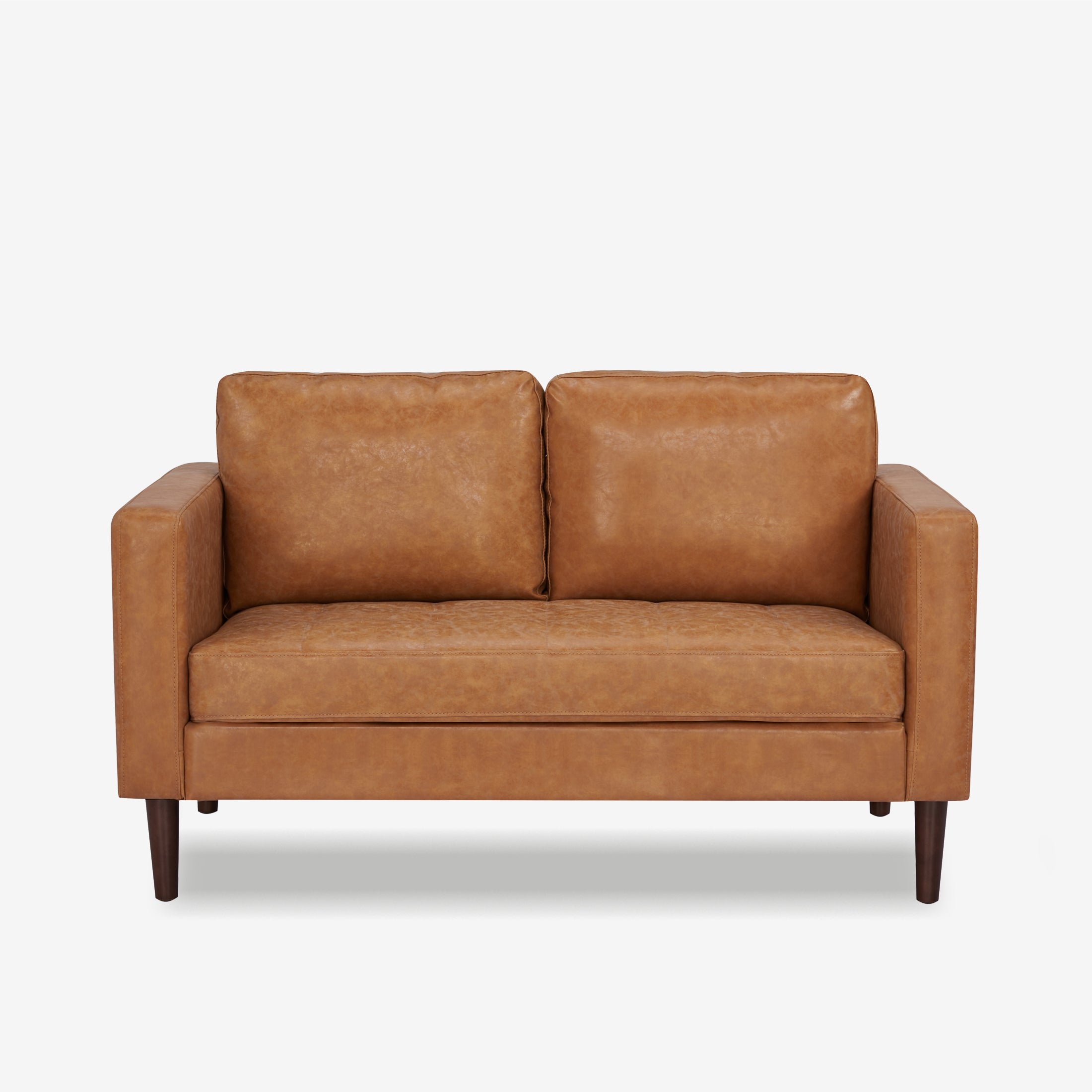 Orlando Loveseat in Faux Leather Camel shown from the front with two loose back cushions, a wide bench seat, track arms, and tapered dark brown legs.