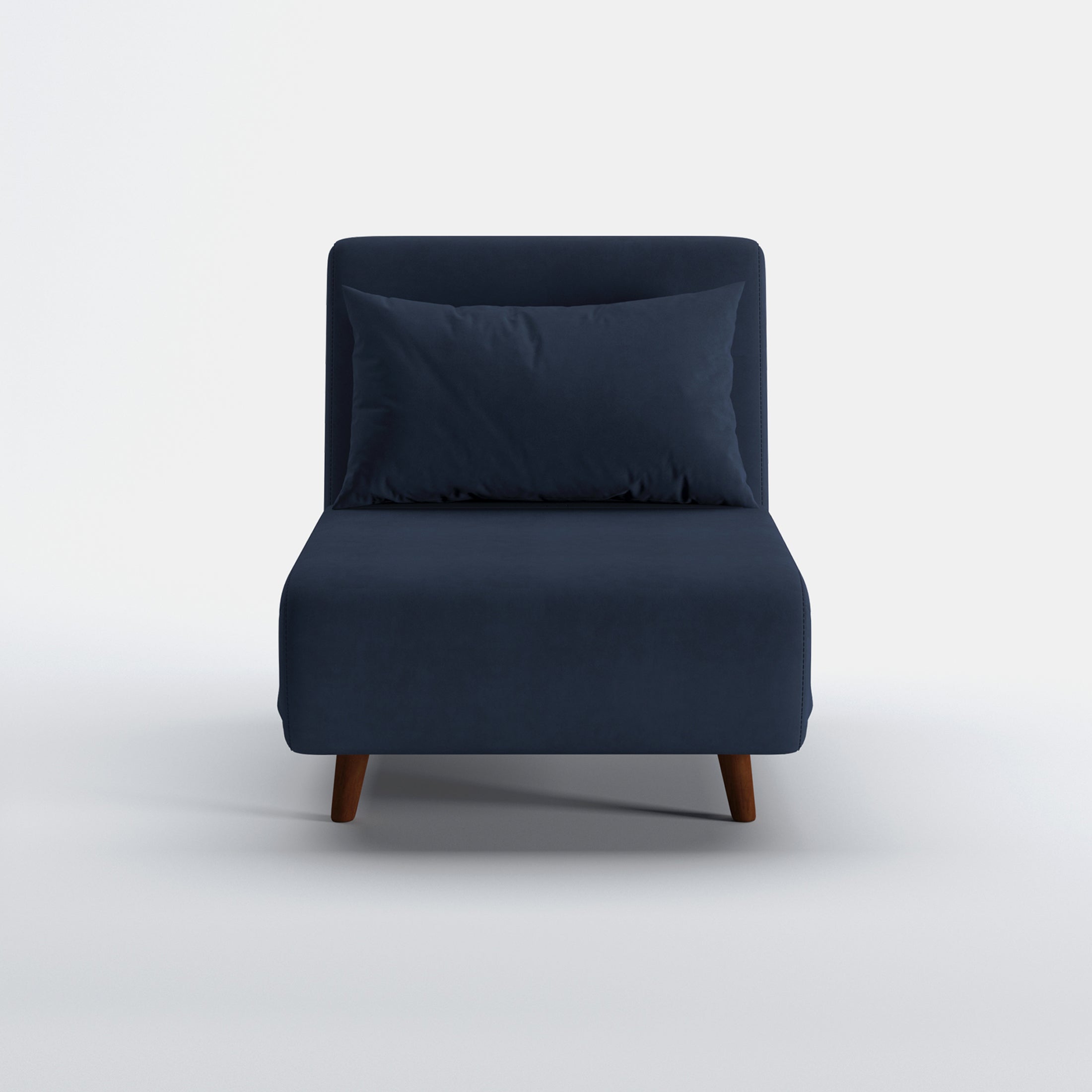 Tustin Convertible Chair in Velvet Blue shown from the front with a matching lumbar pillow, wide armless seat, upholstered backrest, and tapered dark brown wood legs.