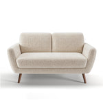 Oakland Loveseat in Boucle Ivory shown from the front with two rounded back cushions, angled upholstered arms, a wide seat cushion, and tapered brown legs