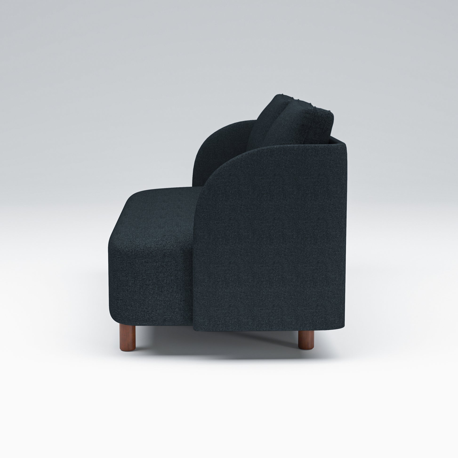 Nora Loveseat in Navy Blue shown from the side with a deep seat profile, gently curved arm panel, loose back cushions, and short brown legs