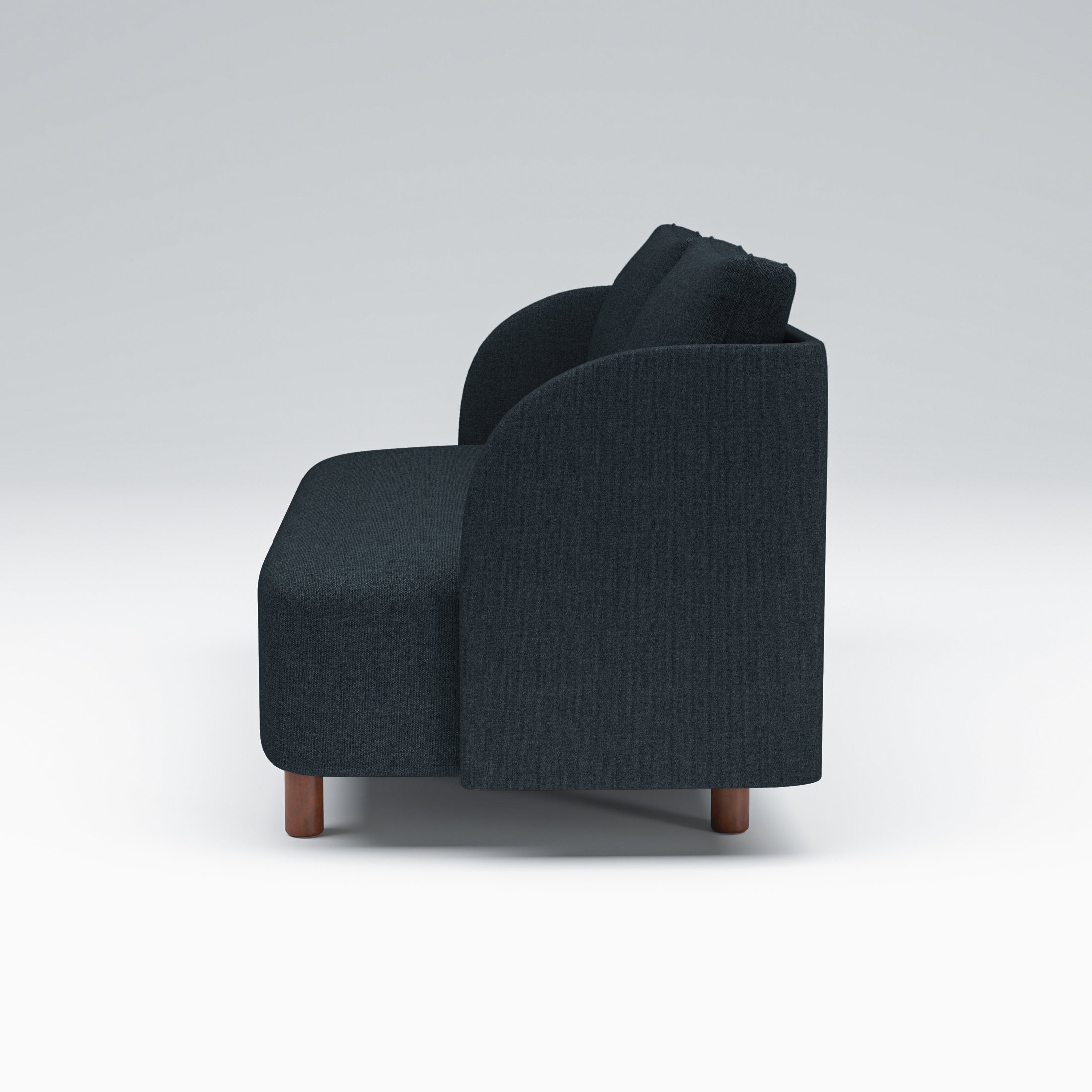 Nora Loveseat in Navy Blue shown from the side with a deep seat profile, gently curved arm panel, loose back cushions, and short brown legs