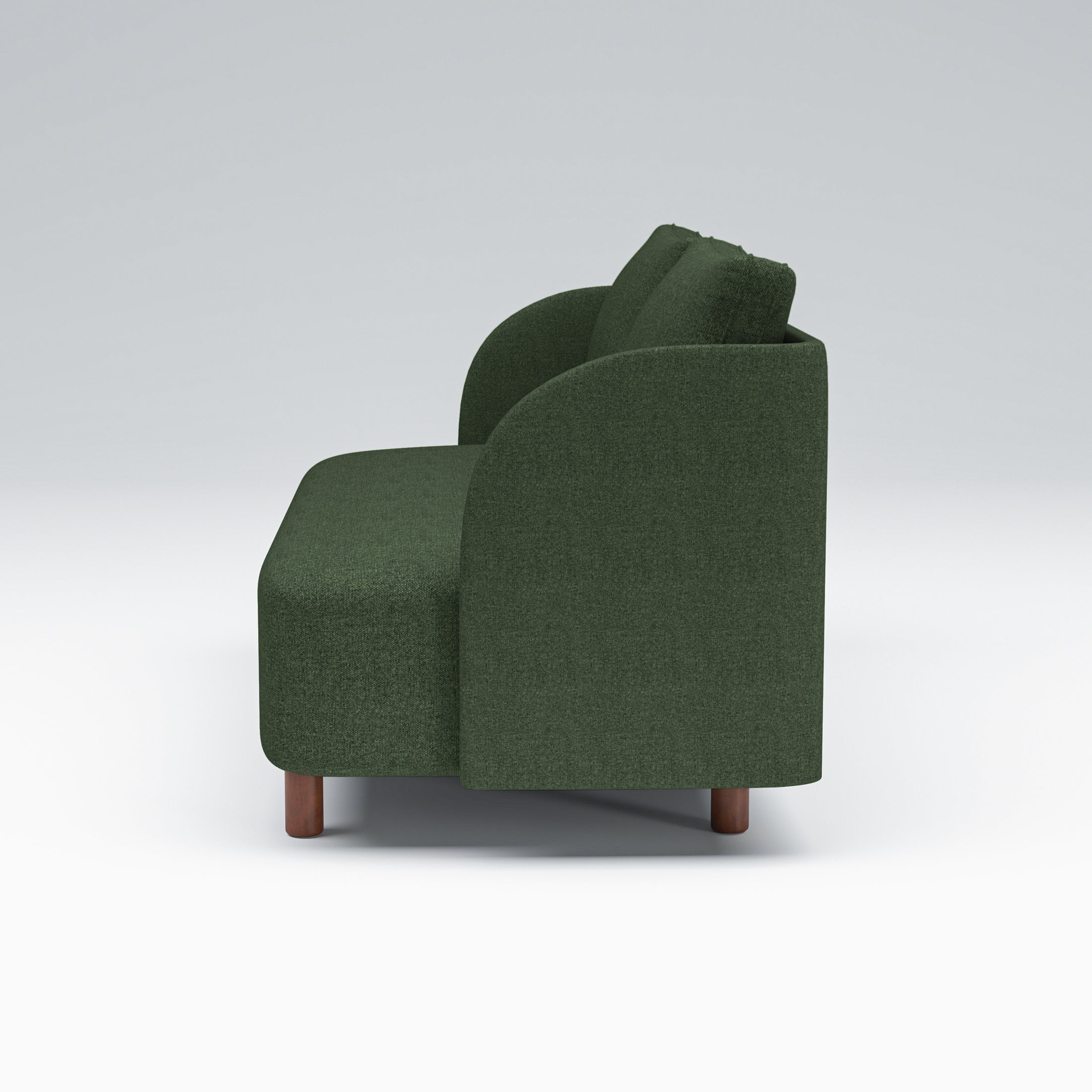Nora Loveseat in Moss Green shown in profile with a deep upholstered seat, curved arm silhouette, loose back cushions, and low brown legs.