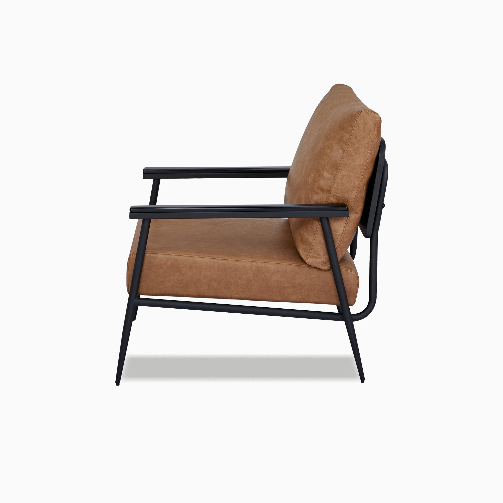 Parker Accent Chair in Faux Leather Light Brown shown from the side with an angled back cushion, deep upholstered seat, straight armrests, and curved black frame