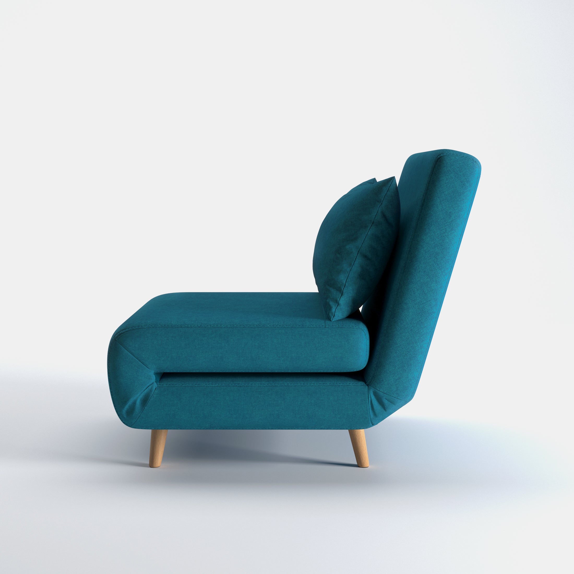 Tustin Convertible Chair in Peacock Blue shown from the side with a thick cushioned seat, reclining backrest, matching lumbar pillow, and tapered wood legs.