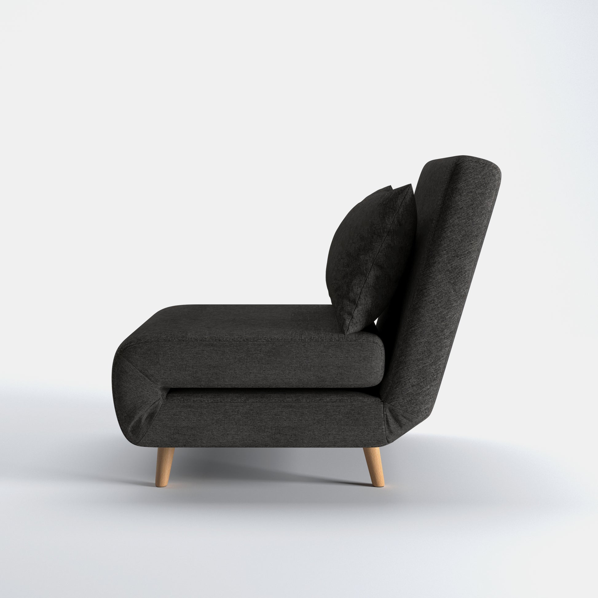 Tustin Convertible Chair in Charcoal shown from the side with a thick cushioned seat, reclining backrest, matching lumbar pillow, and tapered wood legs