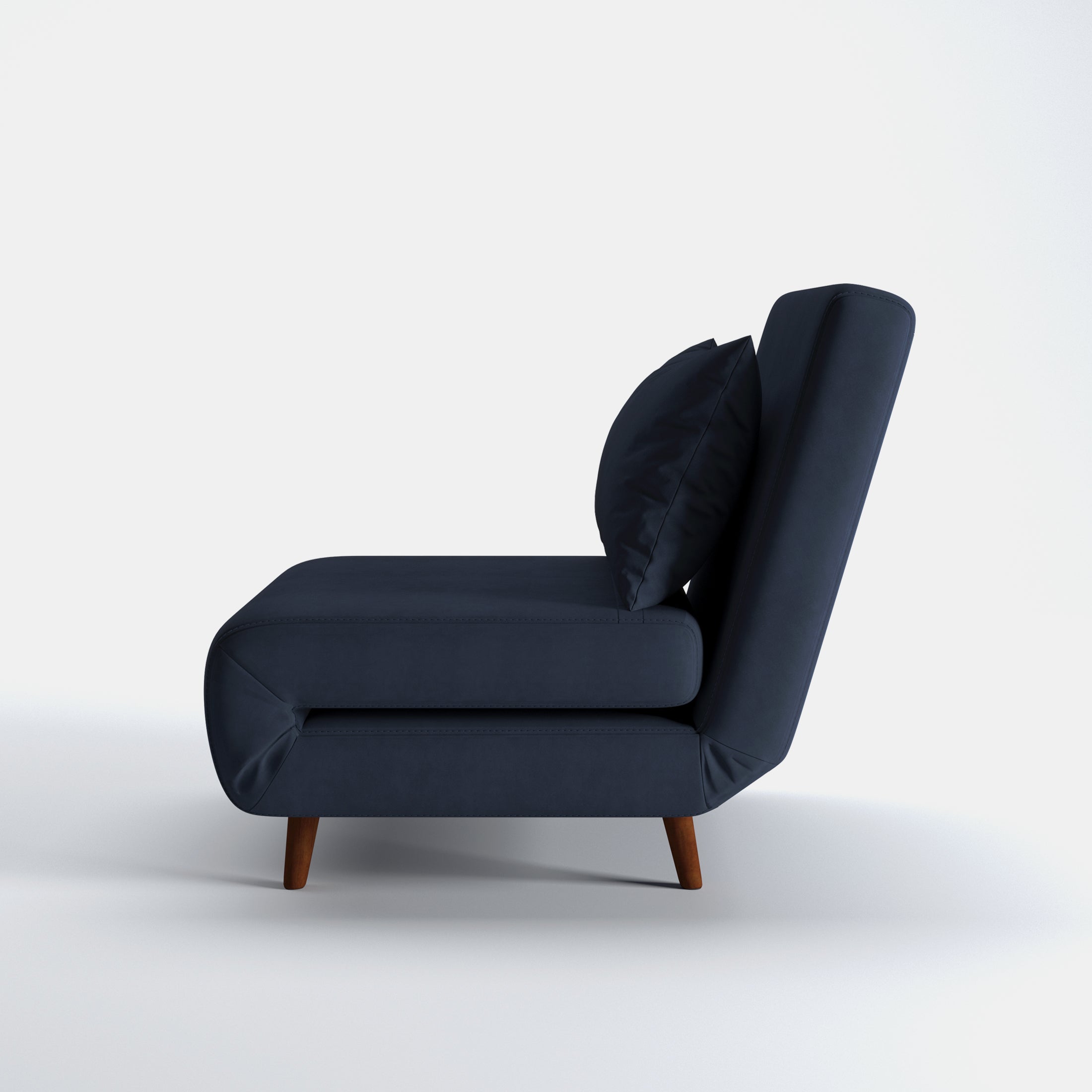 Tustin Convertible Chair in Velvet Blue shown from the side with a thick cushioned seat, reclining backrest, matching lumbar pillow, and tapered dark brown wood legs.