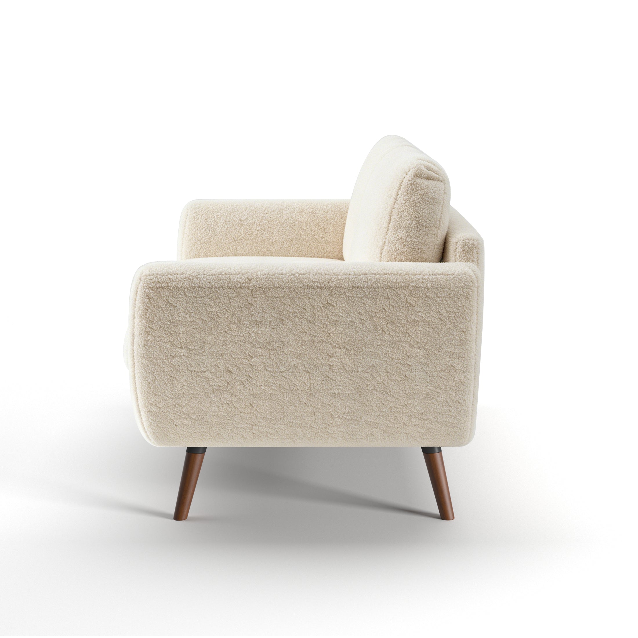 Oakland Loveseat in Boucle Ivory shown from the side, displaying its deep cushioned seat, angled arm profile, rounded back cushions, and tapered brown legs