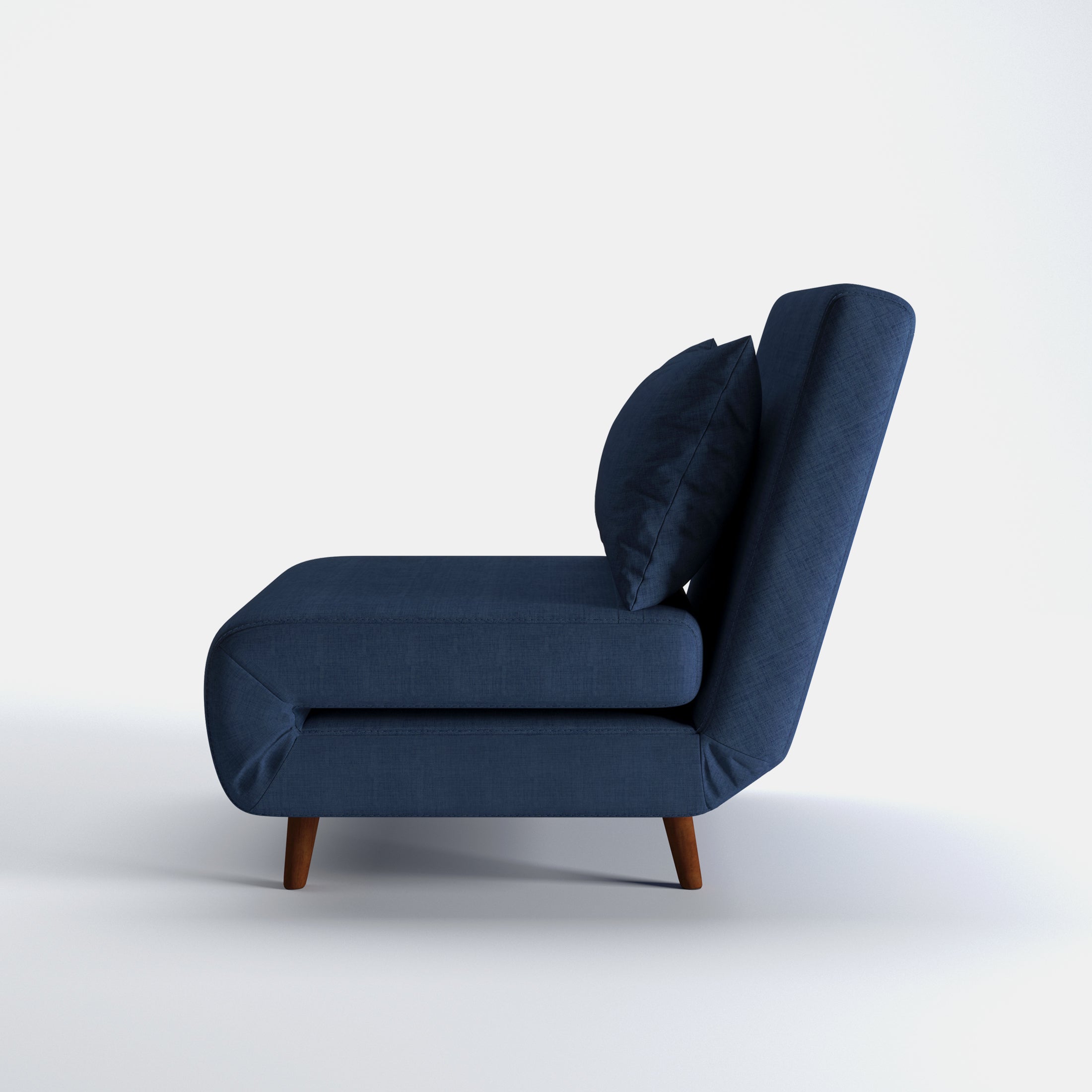 Tustin Convertible Chair in Blue shown from the side with a thick cushioned seat, reclining backrest, matching lumbar pillow, and tapered dark brown wood legs.
