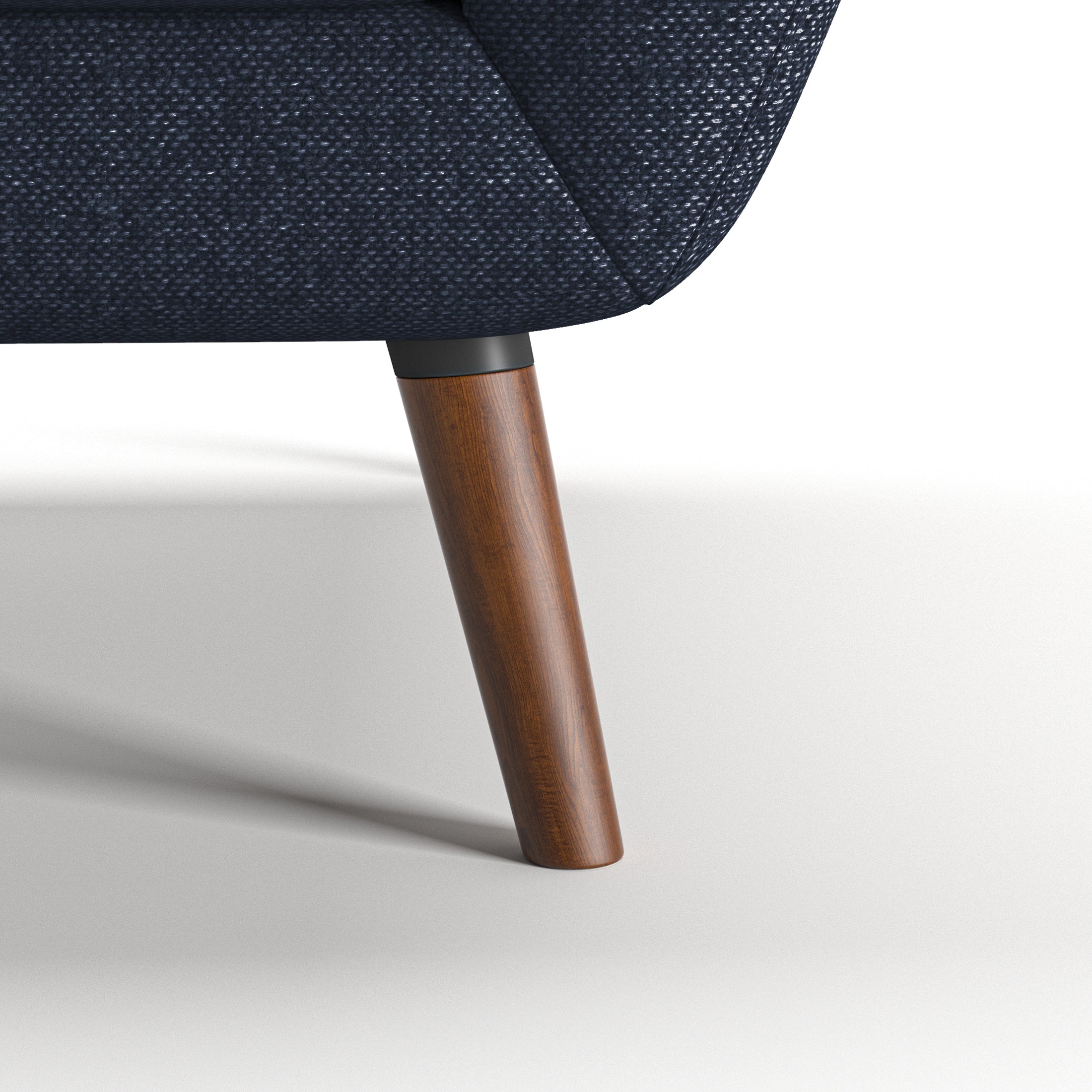 Oakland Loveseat in Navy Blue featuring a close-up of the tapered brown leg, dark connector, curved lower frame, and textured navy woven upholstery