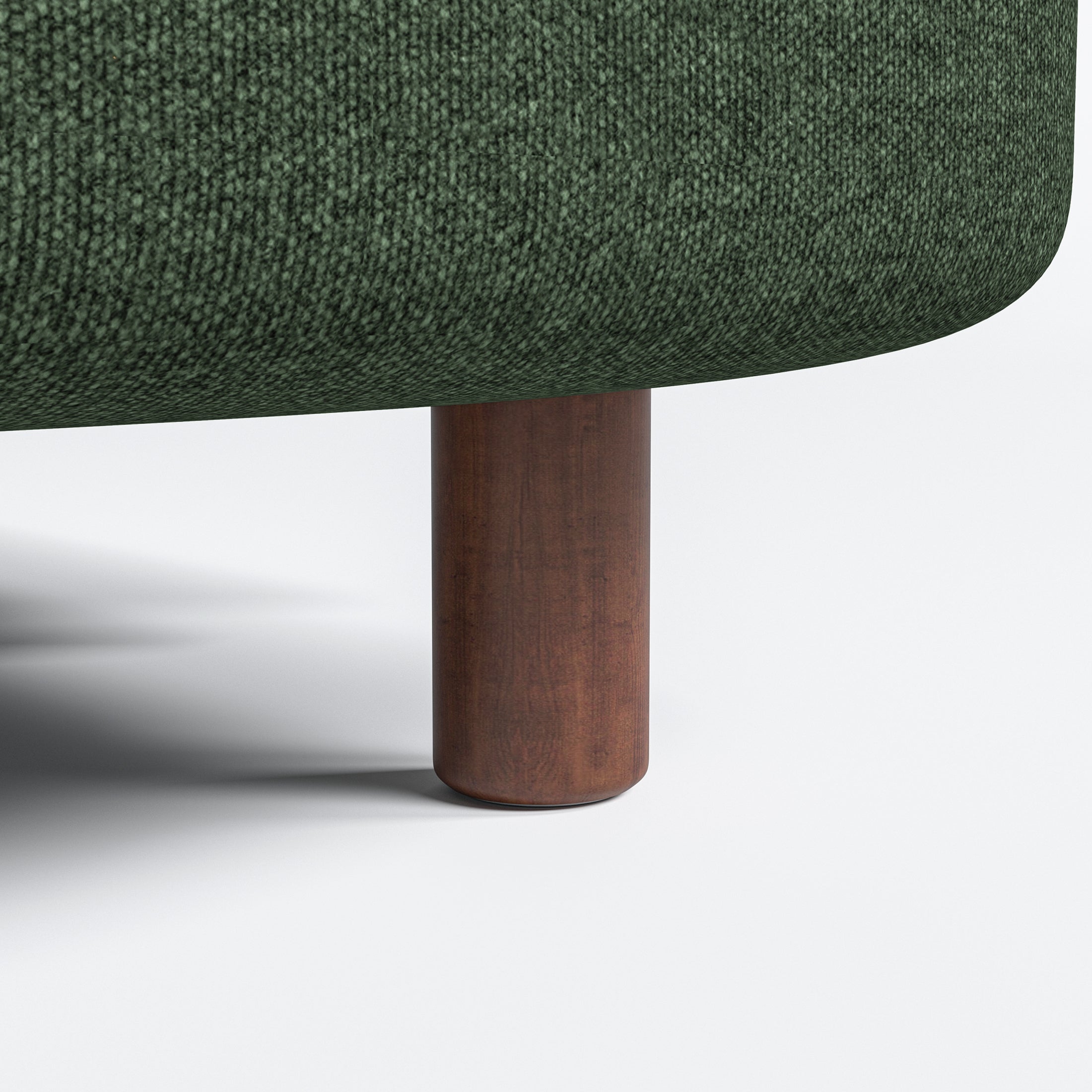 Nora Loveseat in Moss Green featuring a close-up of the rounded brown leg beneath the curved base and finely textured green upholstery.