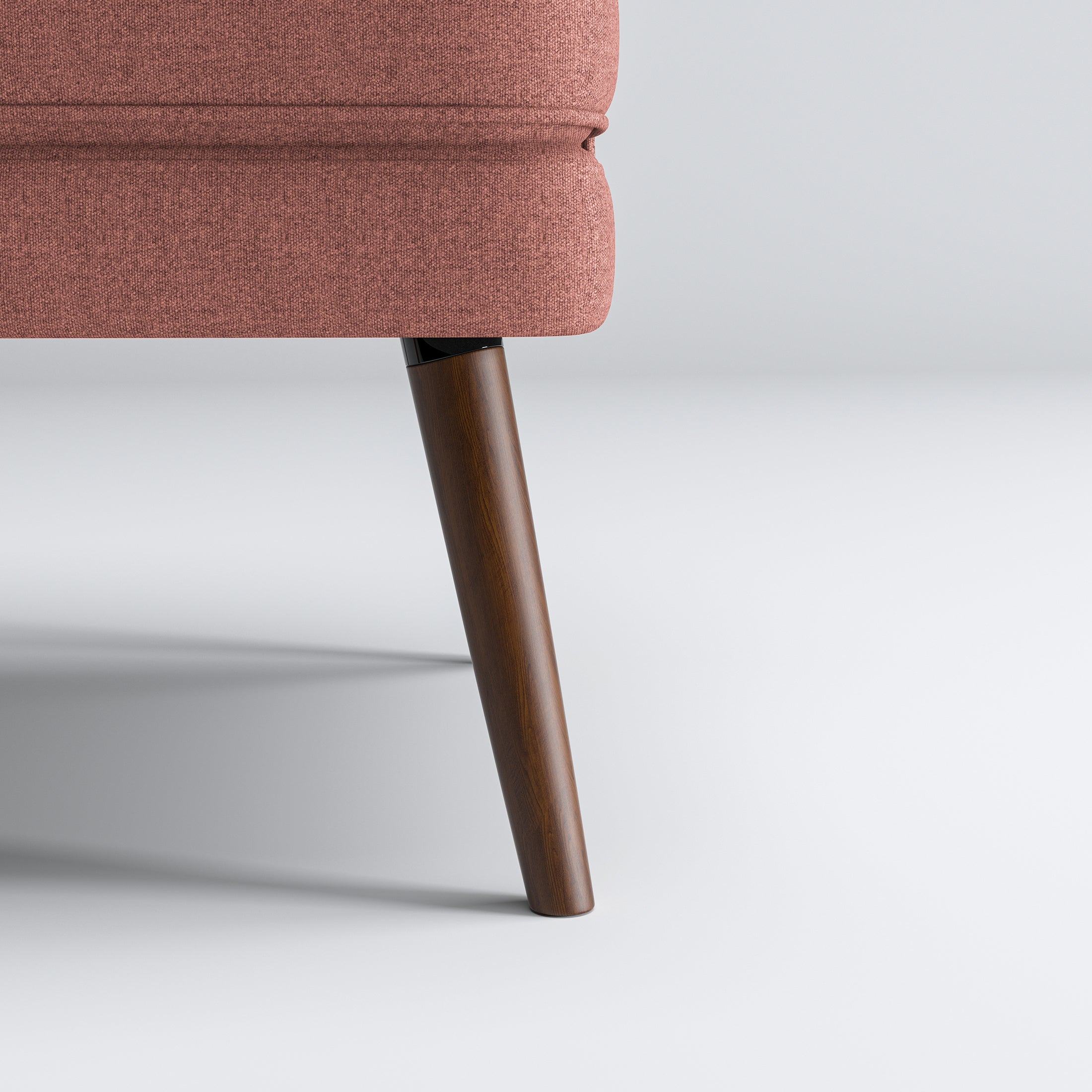 Dana Accent Chair in Faux Linen Dusty Rose featuring a close-up of one tapered brown leg beneath the rounded upholstered base and textured faux linen fabric