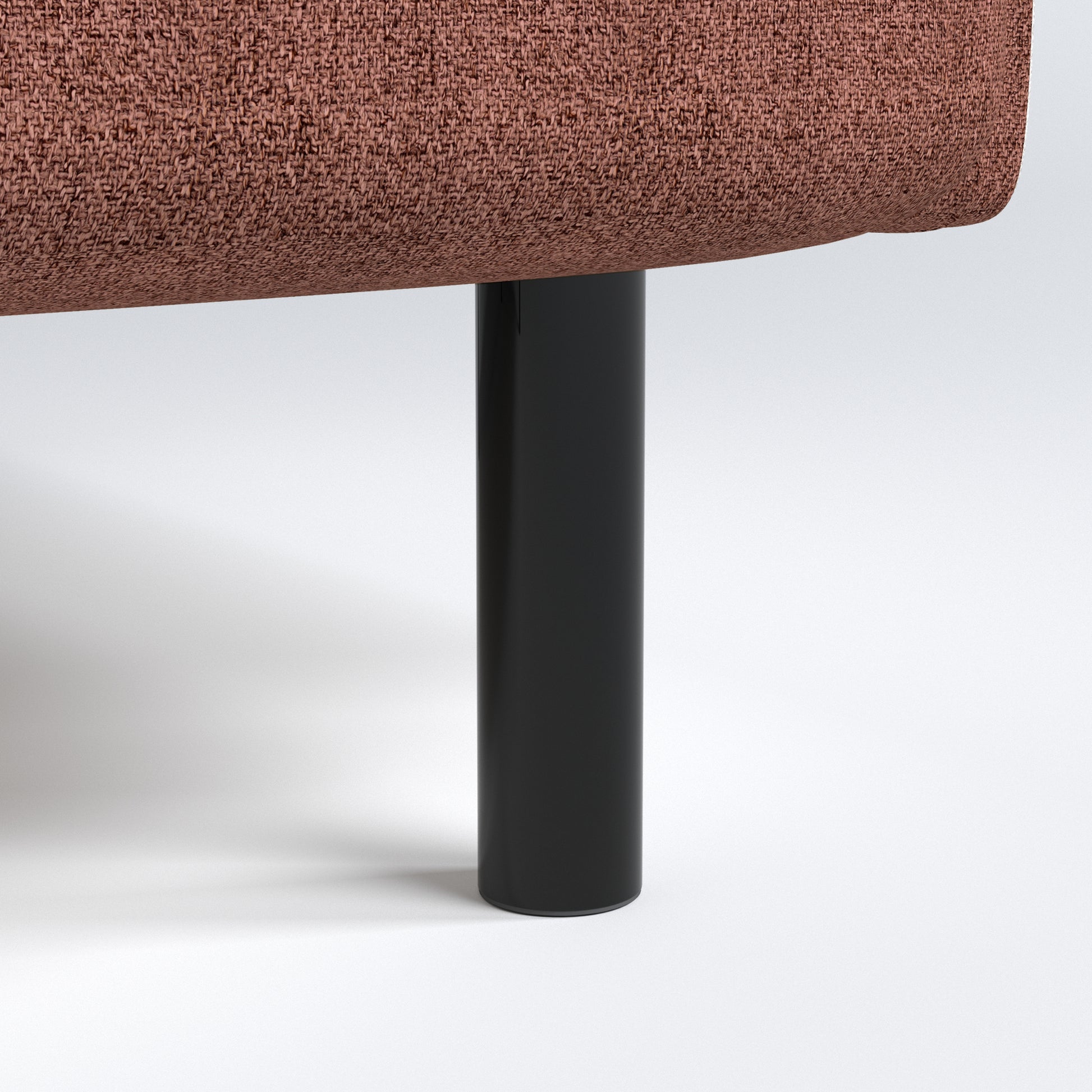 Metro Loveseat in Rosewood Blush featuring a close-up of the black cylindrical leg beneath the rounded seat base and textured woven upholstery.