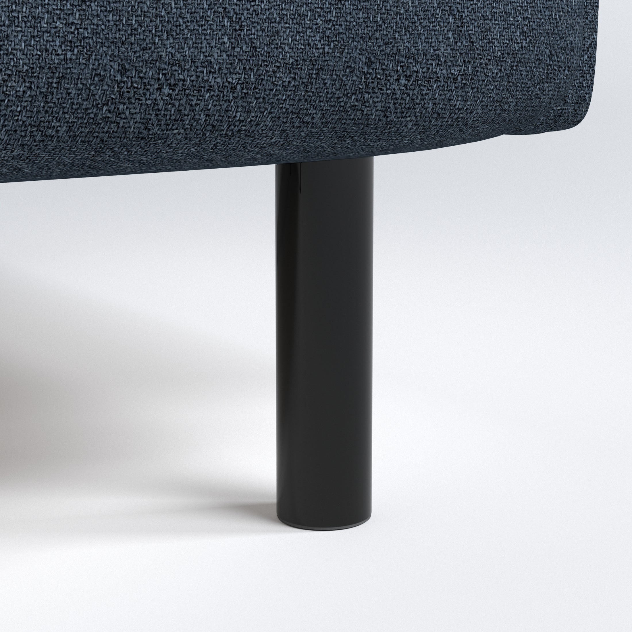 Metro Loveseat in Navy Blue featuring a detailed view of the black cylindrical leg beneath the rounded base and navy woven upholstery.