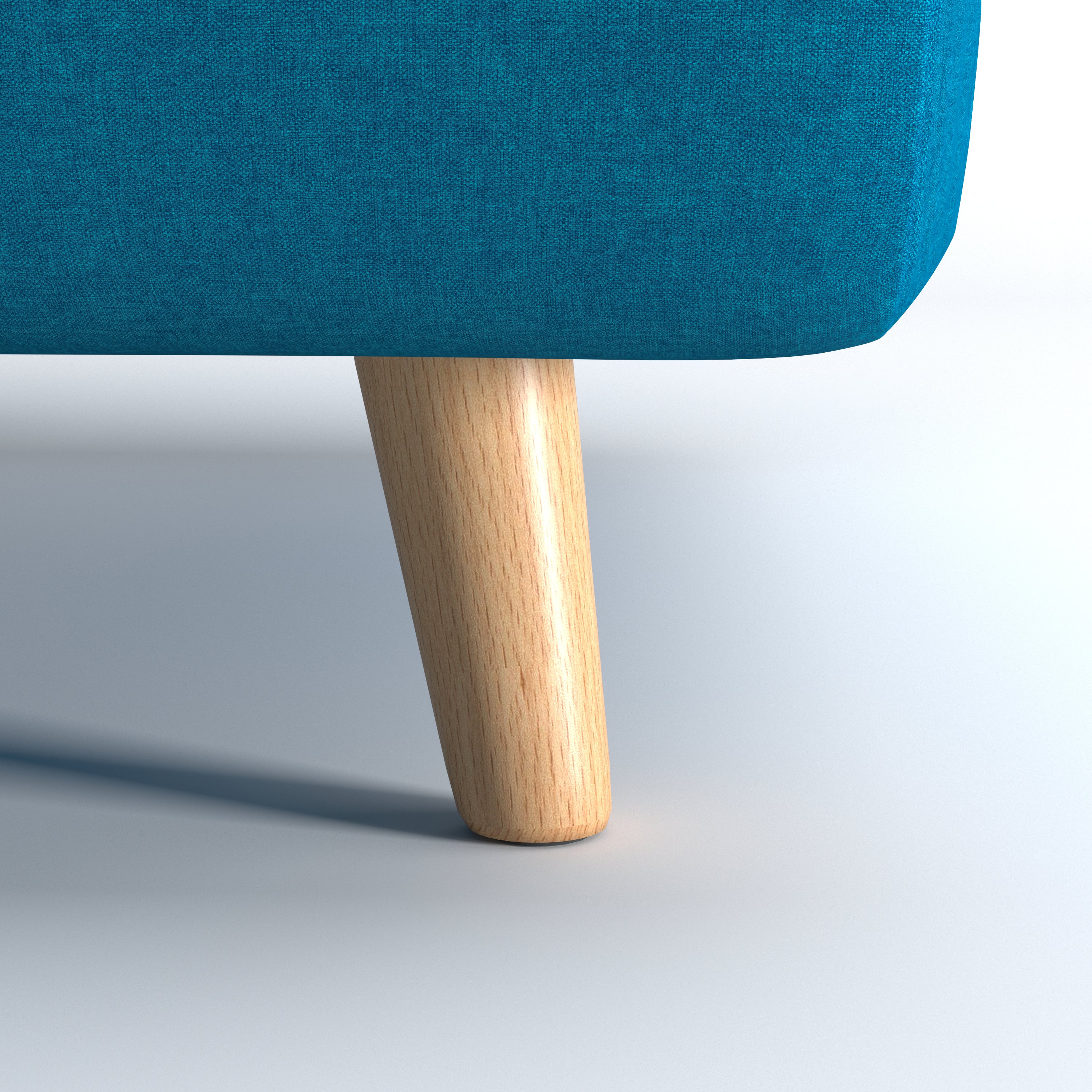 Tustin Convertible Chair in Peacock Blue featuring a close-up of the tapered natural wood leg beneath the rounded base and textured blue upholstery.