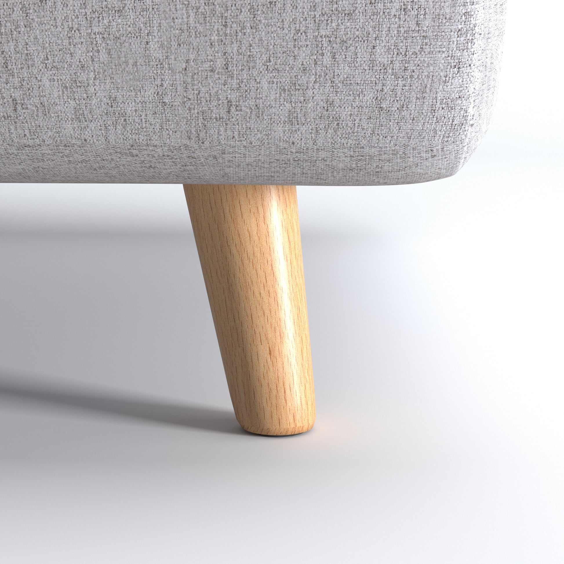 Tustin Convertible Chair in Moonlight featuring a close-up of the tapered natural wood leg beneath the rounded base and textured woven upholstery.