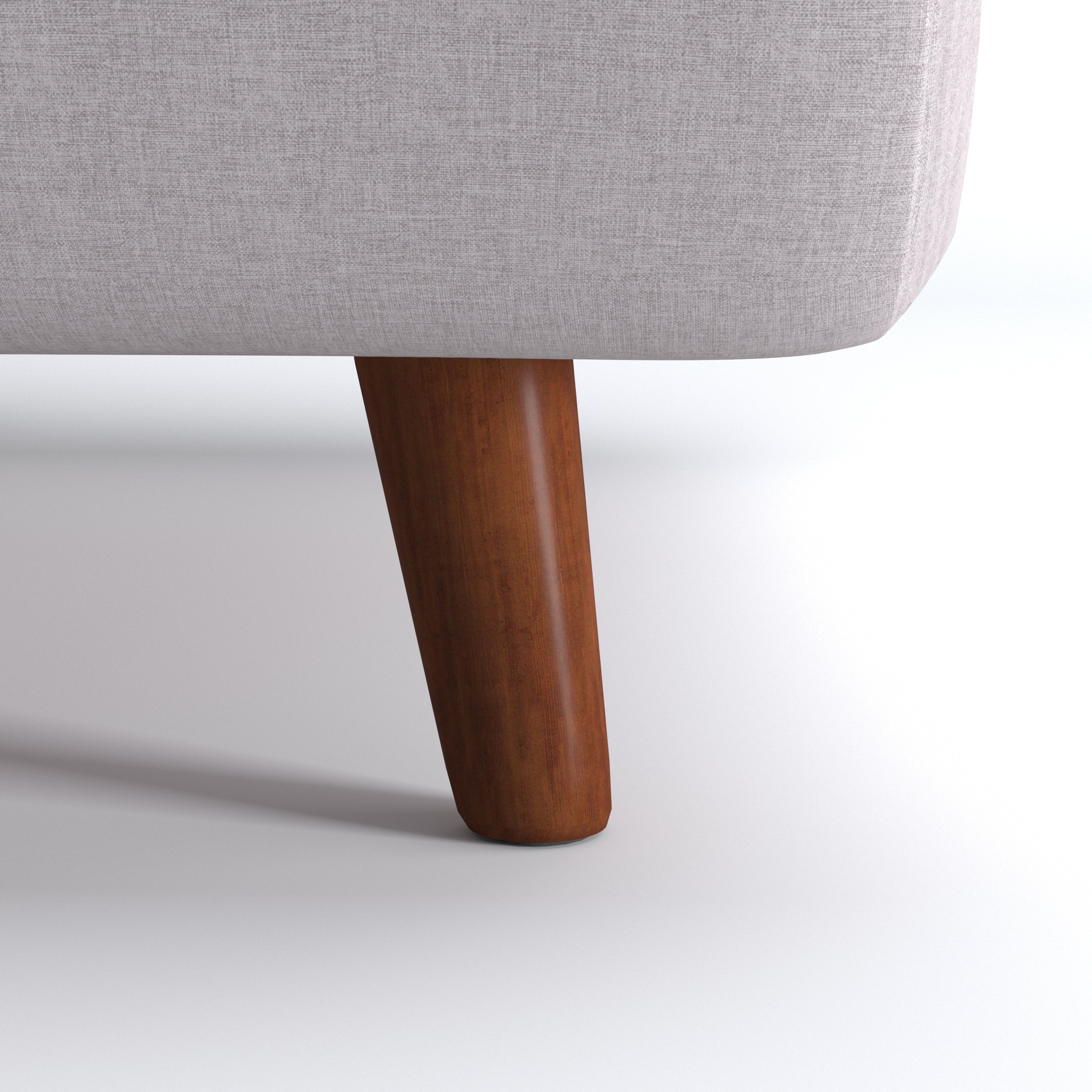 Tustin Convertible Chair in Beige featuring a close-up of the tapered dark brown wood leg beneath the rounded base and textured beige upholstery.