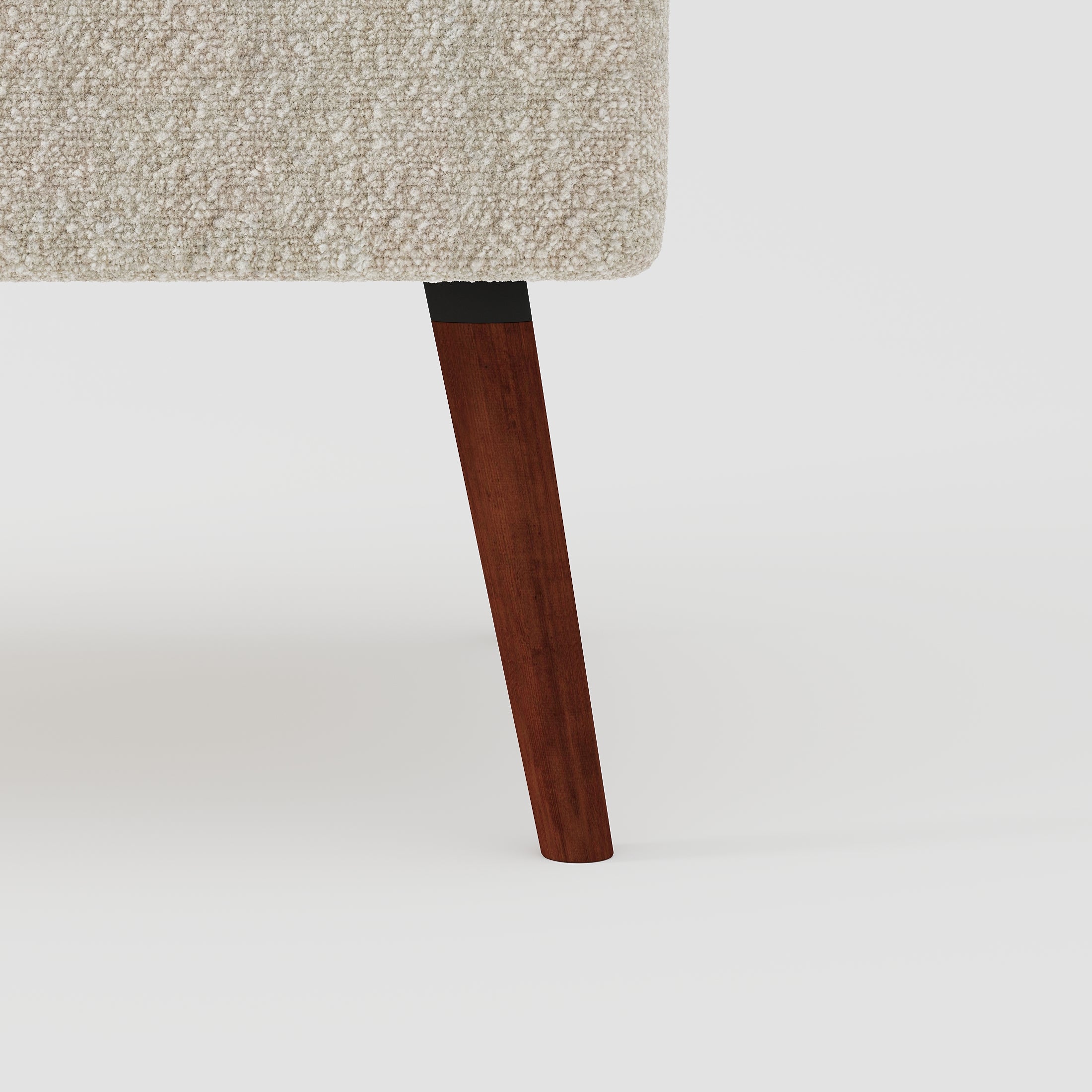 Hollywood Loveseat in Ivory featuring a close-up of the tapered brown wood leg, black connector, and textured ivory upholstery along the lower frame