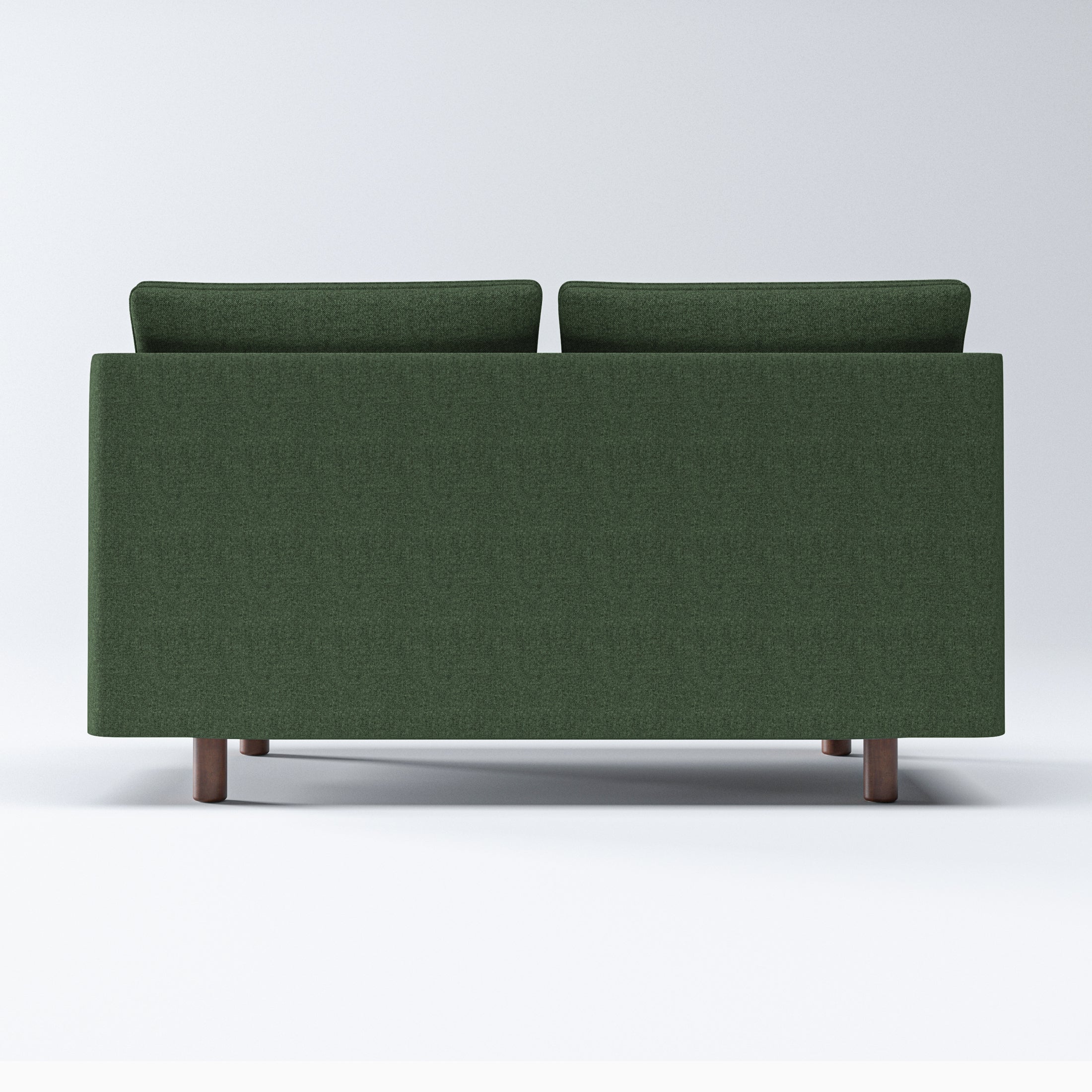Nora Loveseat in Moss Green shown from the back, displaying its wide upholstered rear panel, raised cushion edges, and four short brown legs