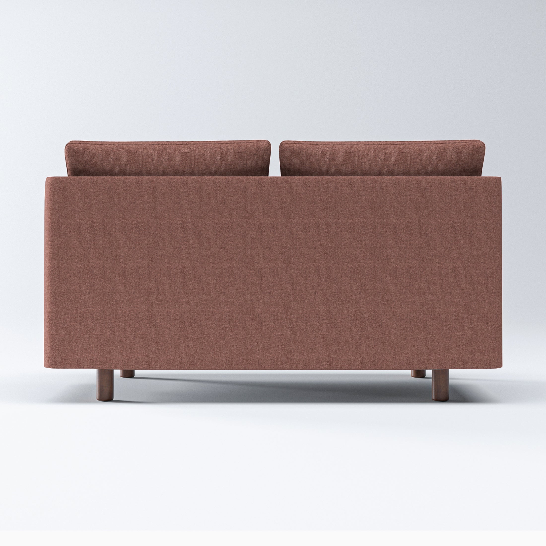 Nora Loveseat in Dusty Rose shown from the rear with a clean upholstered back panel, two visible cushion tops, and short cylindrical brown legs
