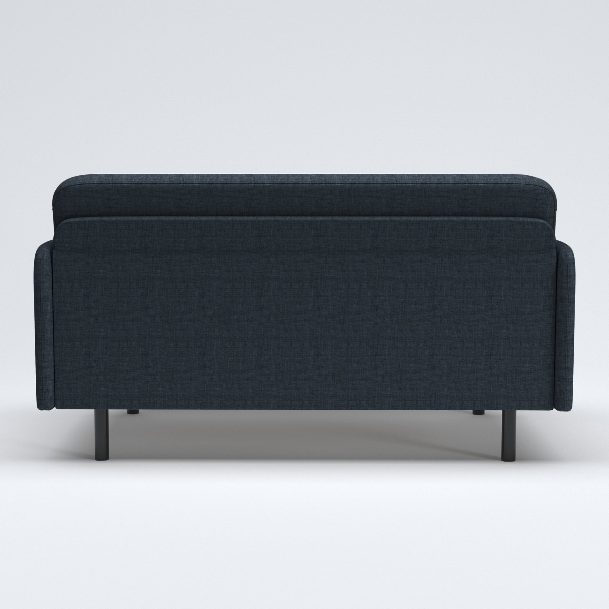 Metro Loveseat in Navy Blue shown from the rear, featuring a wide upholstered back panel, rounded upper edge, slim side panels, and short black legs.