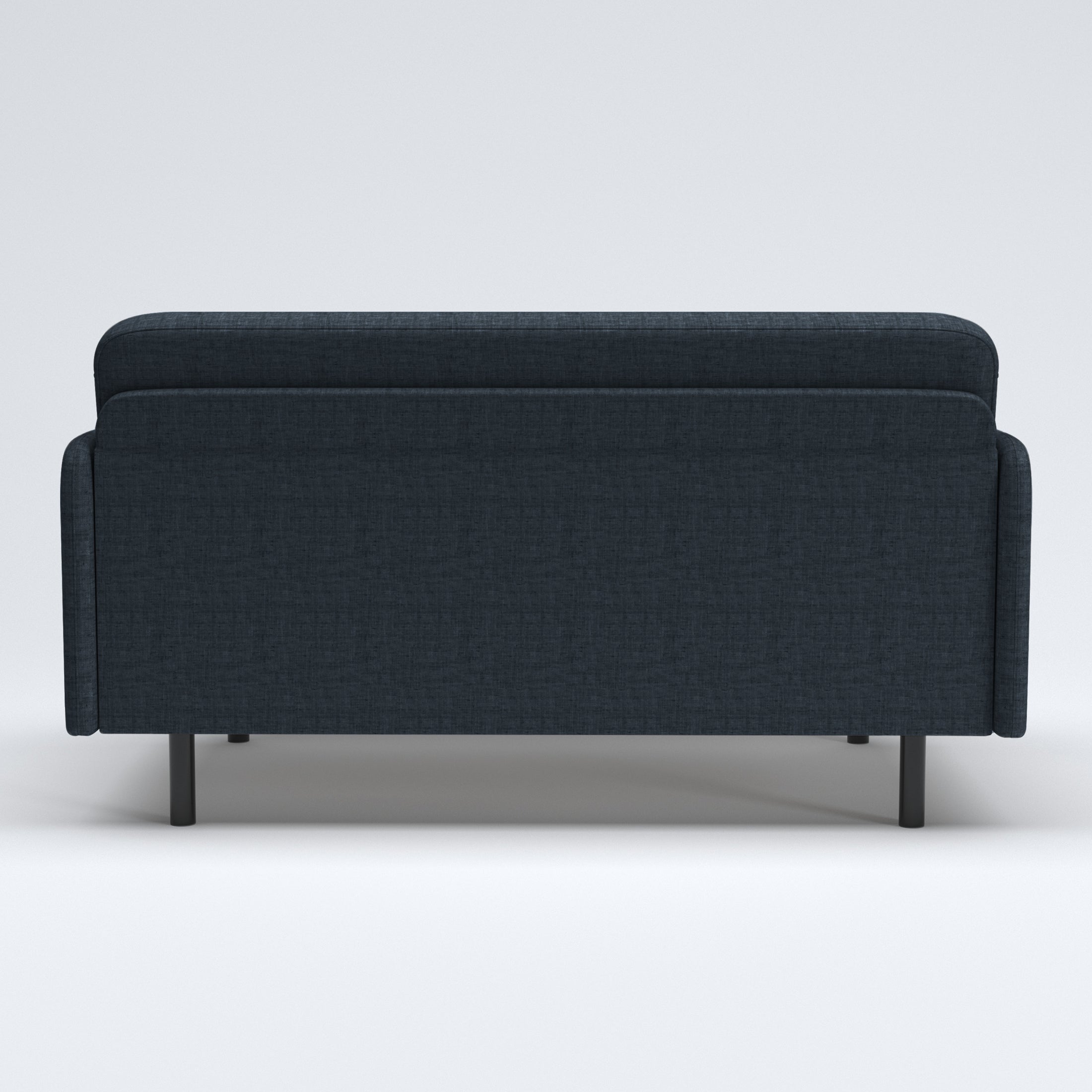 Metro Loveseat in Navy Blue shown from the rear, featuring a wide upholstered back panel, rounded upper edge, slim side panels, and short black legs.