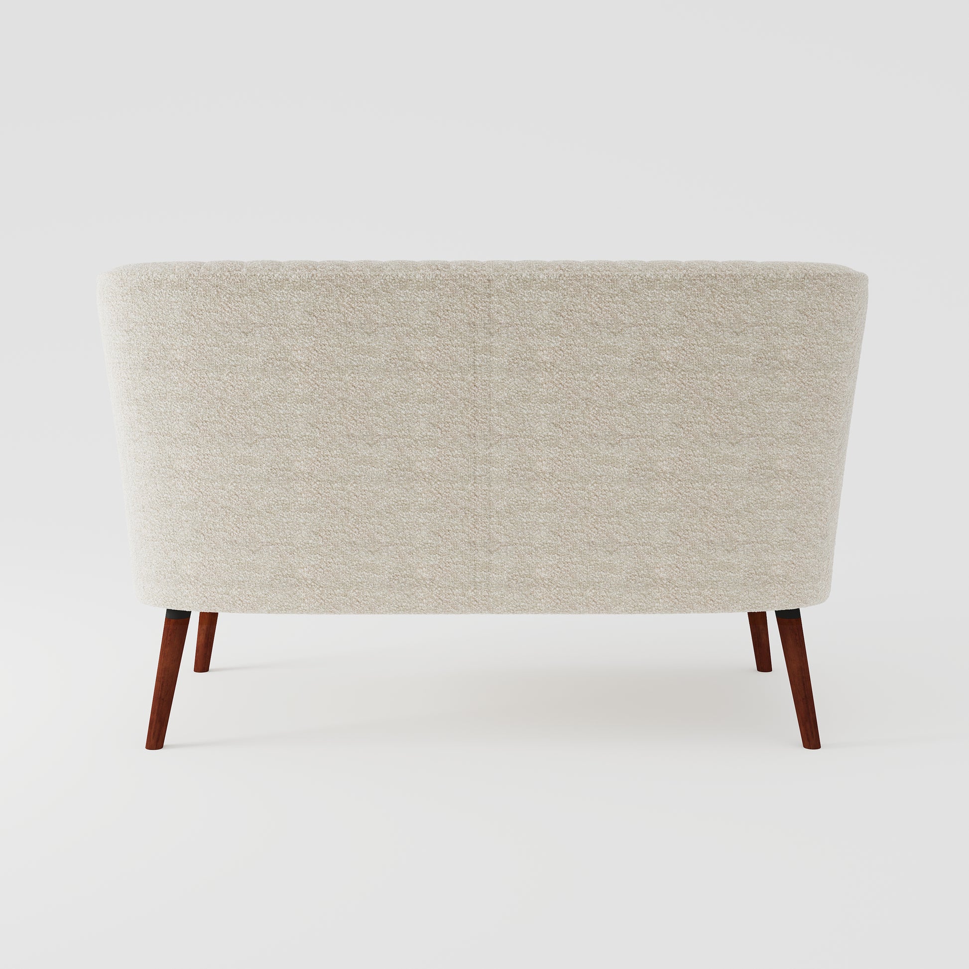 Hollywood Loveseat in Ivory shown from the back, featuring a clean textured upholstered panel, gently curved silhouette, and four angled brown wood legs