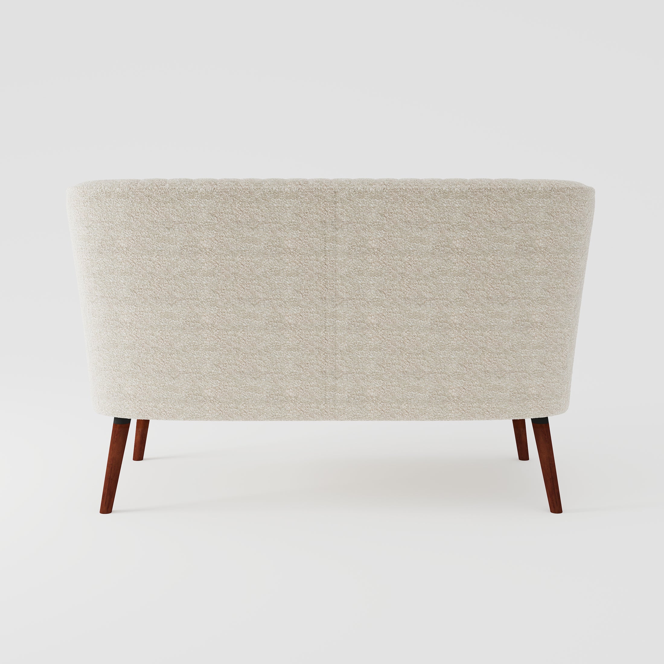 Hollywood Loveseat in Ivory shown from the back, featuring a clean textured upholstered panel, gently curved silhouette, and four angled brown wood legs