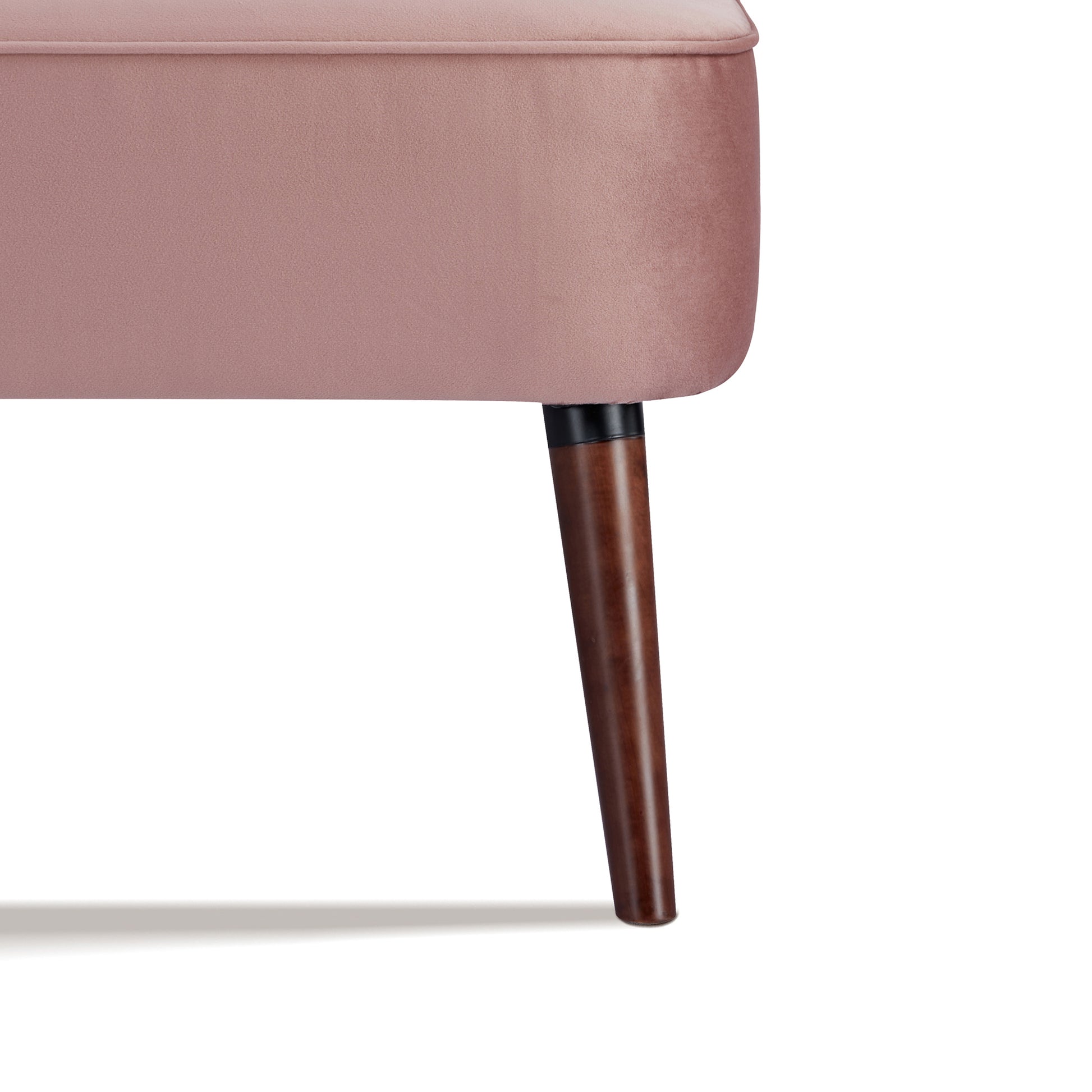 Hollywood Loveseat in Velvet Blush featuring a close-up of one tapered brown leg beneath the rounded blush velvet base and piped seat edge