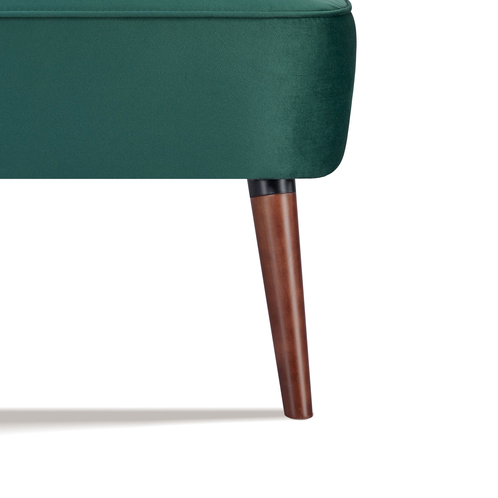 Hollywood Loveseat in Velvet Green featuring a close-up of one tapered brown leg beneath the rounded green velvet base and piped seat edge
