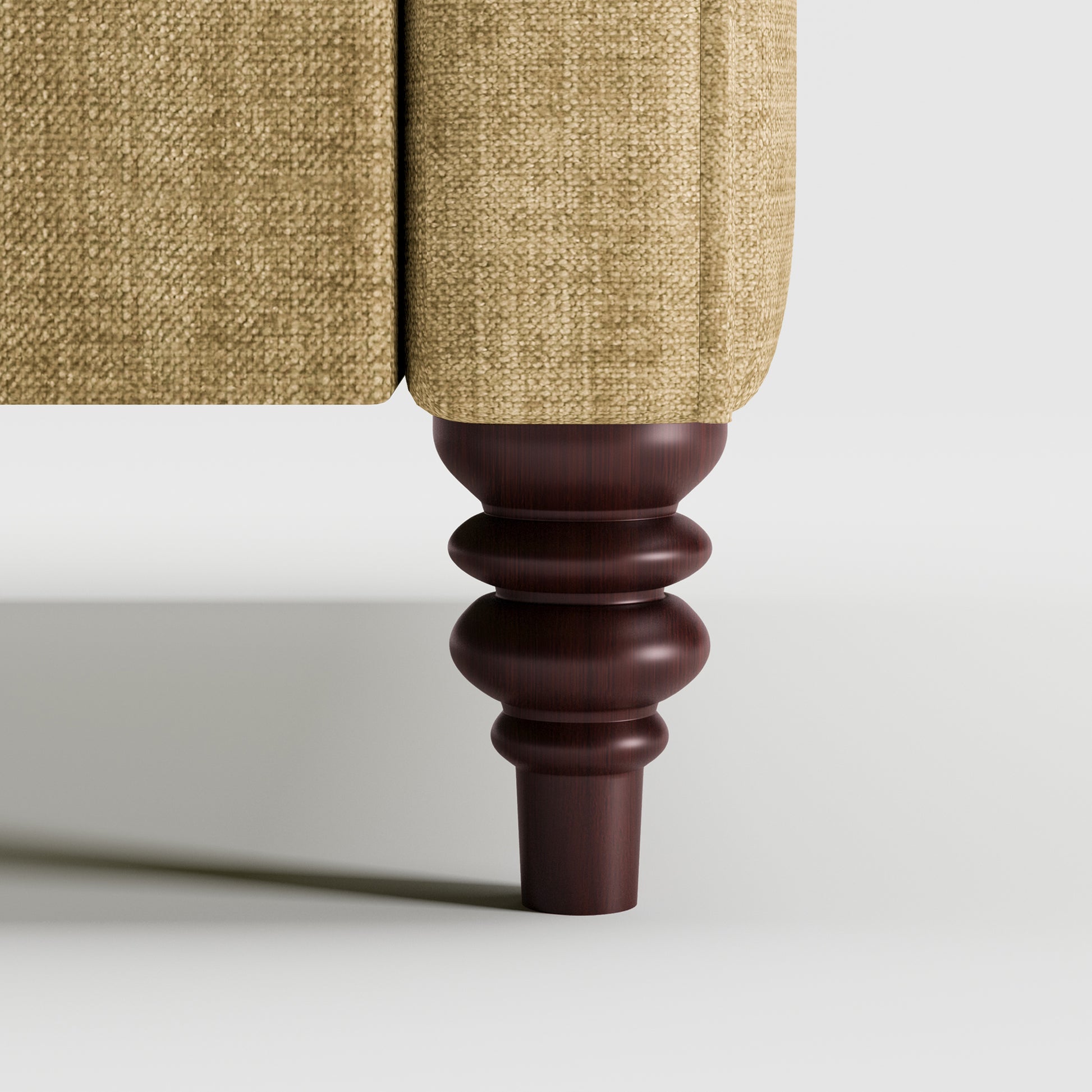 Madison Loveseat in Sand Beige featuring a close-up of the decorative turned dark brown leg beneath the upholstered arm and textured sand beige fabric.