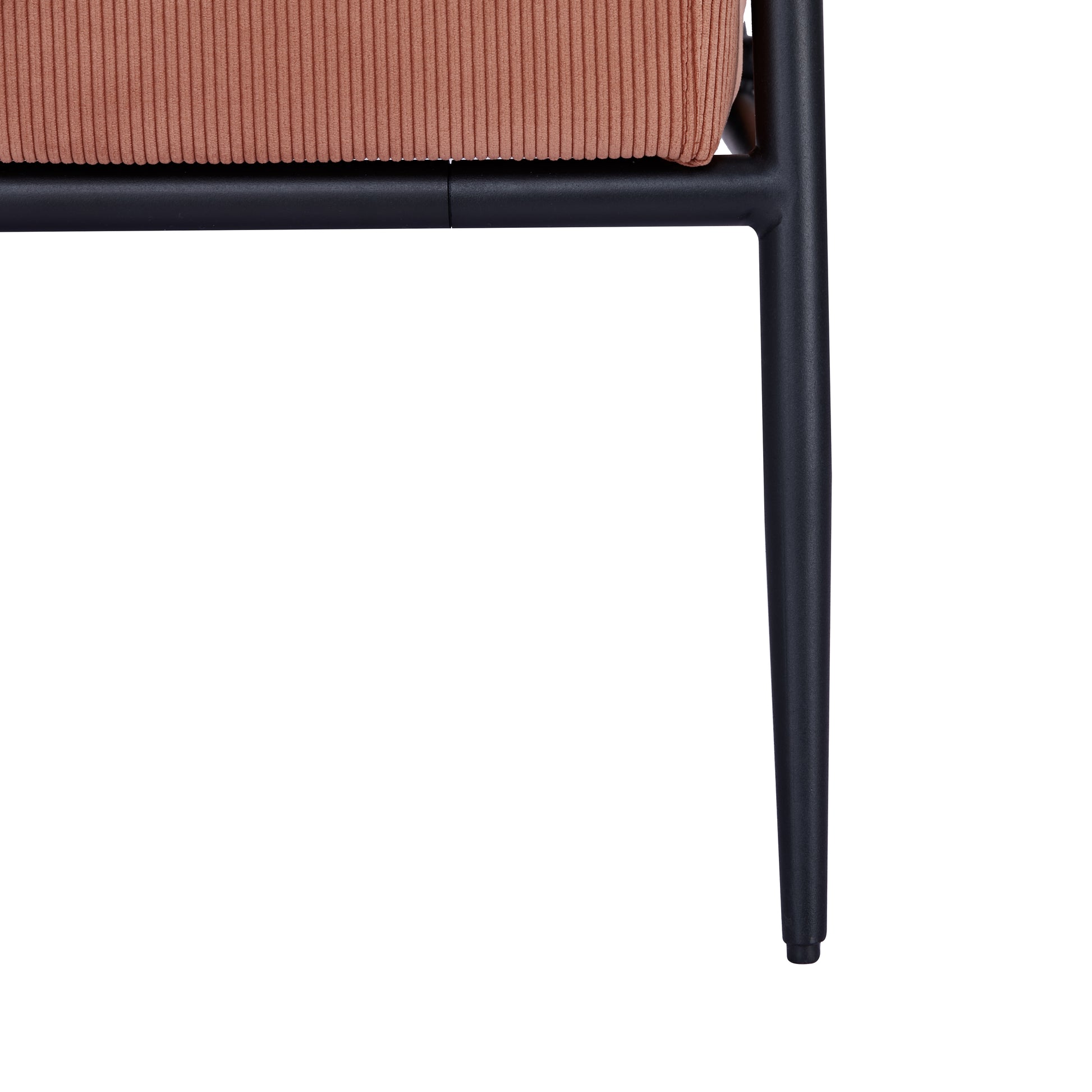 Parker Accent Chair in Corduroy Orange featuring a close-up of the ribbed upholstery, black seat support, frame connection, and tapered metal leg
