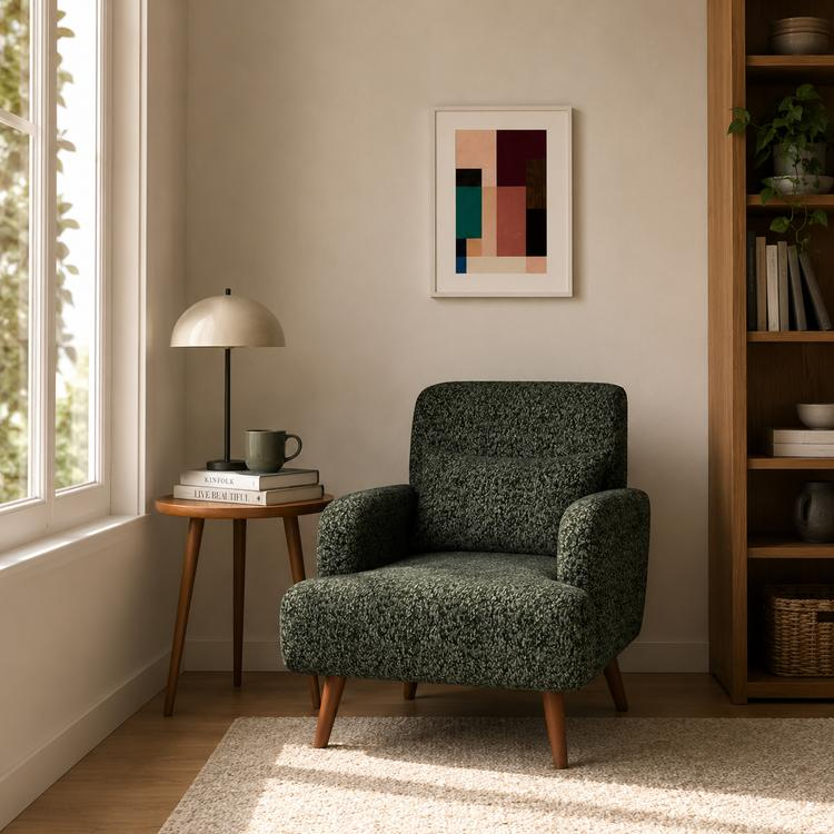Dark green textured accent chair with wooden legs in a cozy reading corner.