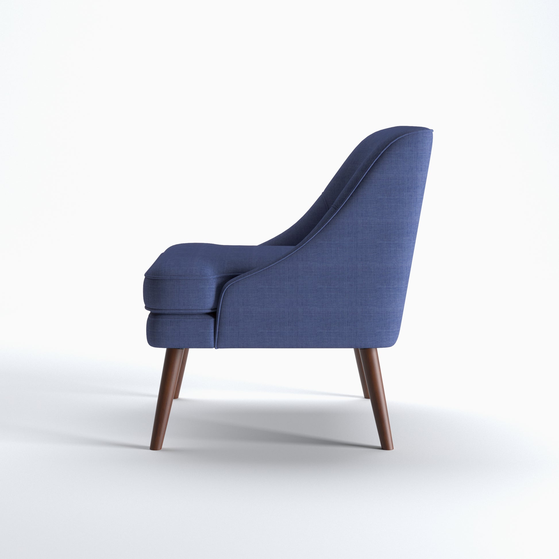 Dana Accent Chair in Faux Linen Blue shown from the side with a gently sloped back, integrated arm profile, thick seat cushion, and angled brown legs