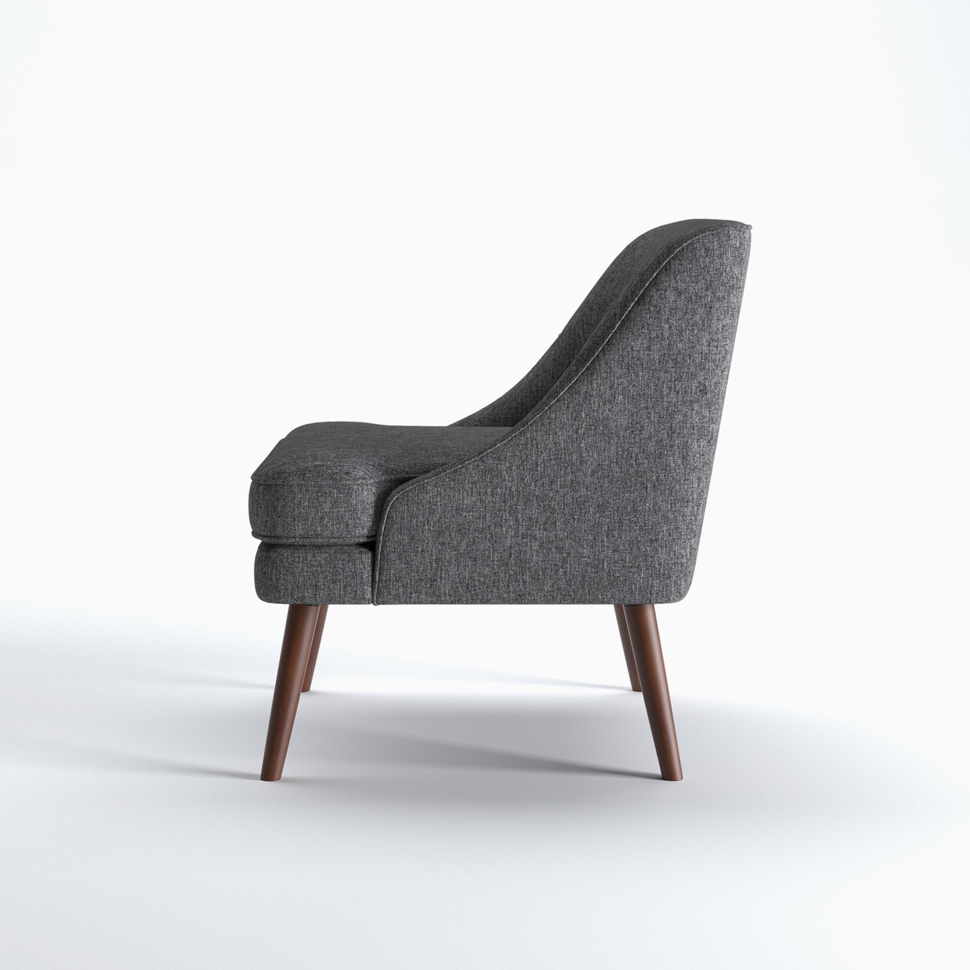 Dana Accent Chair in Faux Linen Dark Gray shown from the side with a gently sloped back, integrated arm profile, thick seat cushion, and angled brown legs